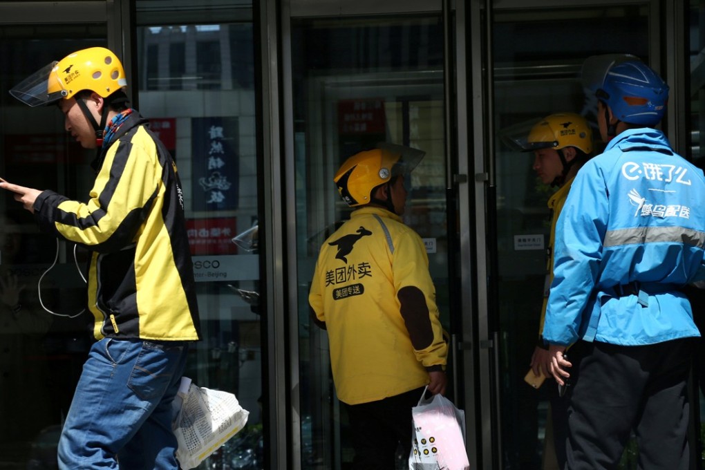 Drivers of food delivery service Ele.me (in blue) and Meituan (in yellow) are seen in Beijing on April 11, 2018. Photo: Reuters