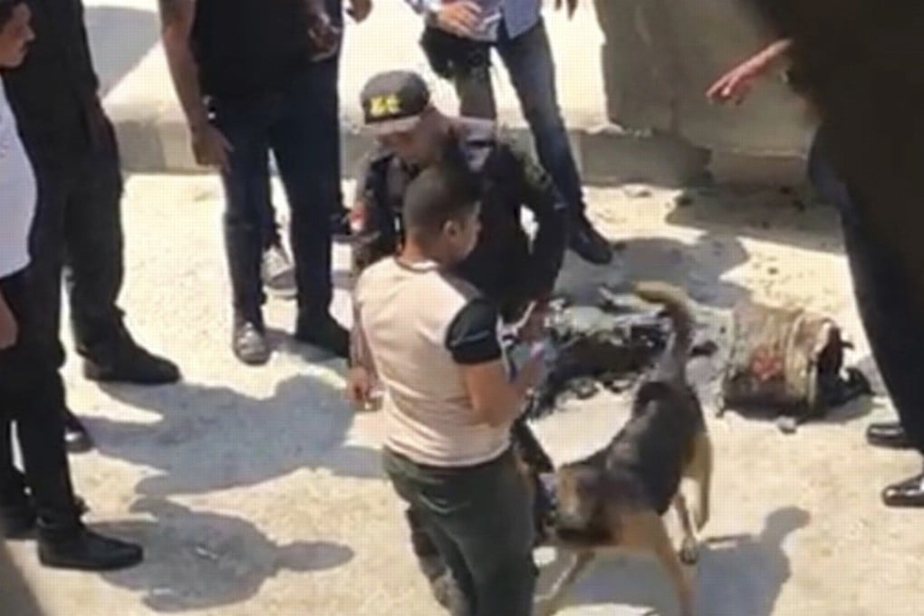 Egyptian security officials stand near the scene where they arrested a man carrying a crude explosive device near the heavily fortified US Embassy in Cairo on Tuesday. Photo: AP