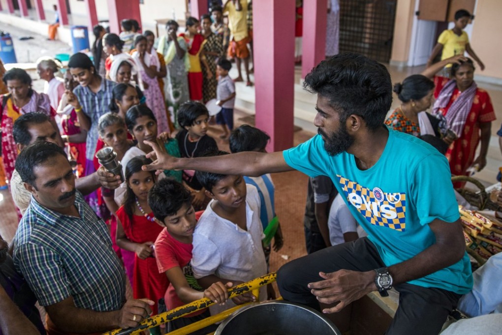 Volunteers serve tea and snacks to flood victims, at a relief camp set up at Sree Narayana College Cherthala in Alappuzha, Kerala, on August 23. Hundreds have died and at least 800,000 been displaced in the southern Indian state’s worst floods in a century. Photo: Bloomberg
