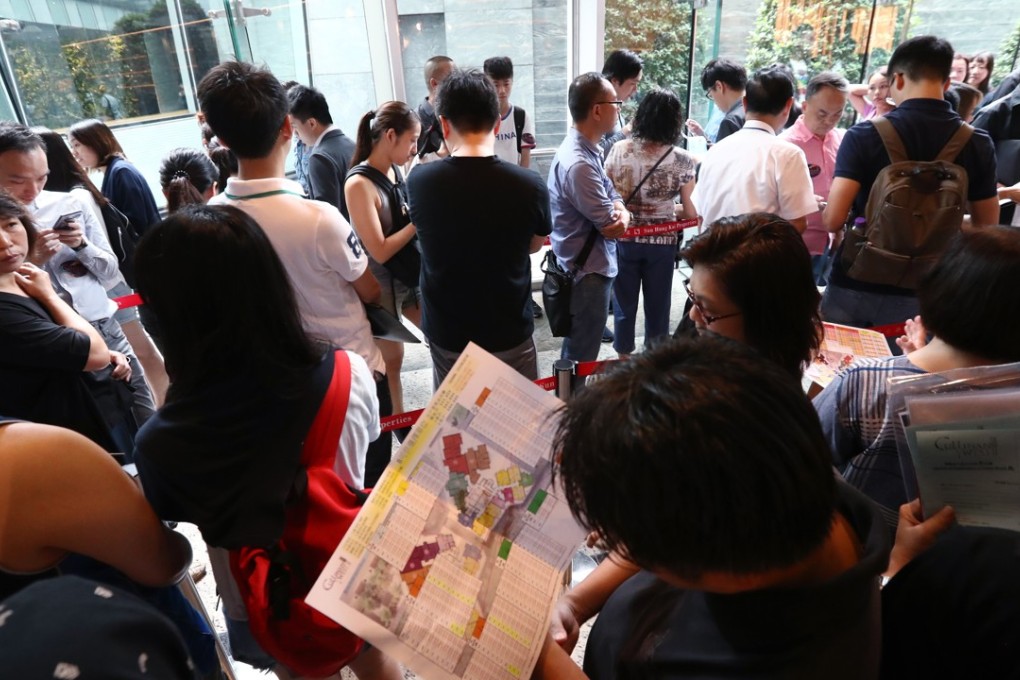 Potential buyers queue up for properties in Hong Kong. Developers are offering big mortgages to push sales, raising concerns over defaults should interest rates rise. Photo: Nora Tam