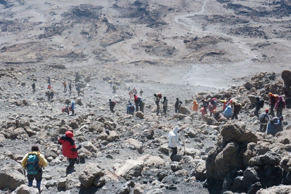 The dusty descent from Gilman’s Point to the Kibo Huts campsite on Mount Kilimanjaro. Picture: Alamy