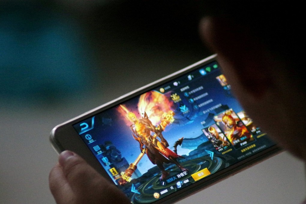 A child plays the game Honour of Kings by Tencent at home in China. Photo: Reuters