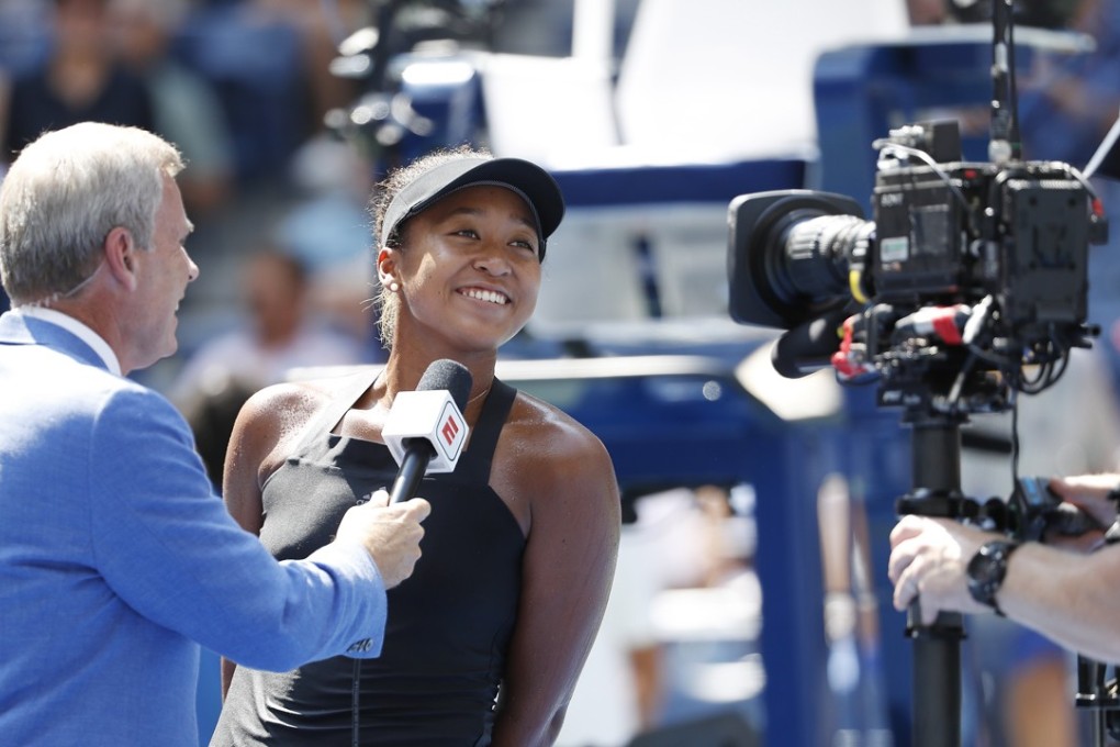 Naomi Osaka of Japan smiles during a post-match on-court interview after defeating Lesia Tsurenko at the US Open. Photo: EPA