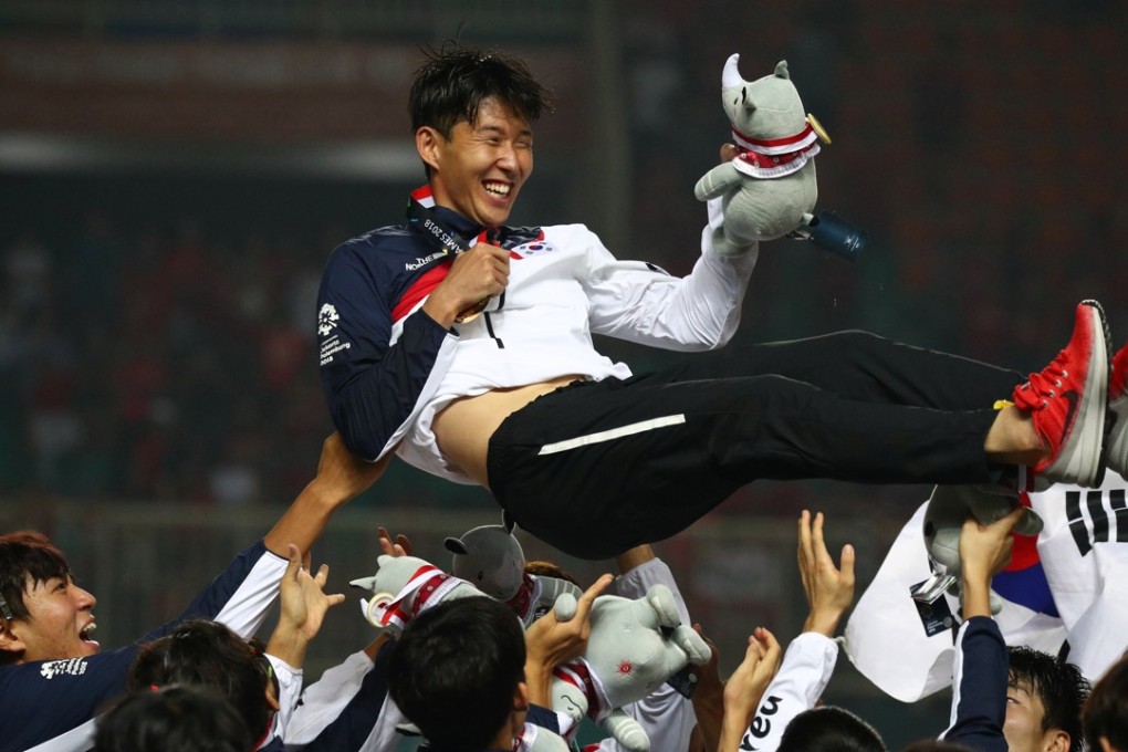 Son Heung-min is lifted off the air by his South Korea teammates after winning gold in the soccer tournament at the Asian Games. Photo: Reuters