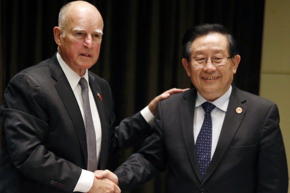 California governor Jerry Brown shakes hands with China's Science and Technology Minister Wan Gang after signing a memorandum of understanding of Clean Technology in Beijing in June 2017. Photo: AP