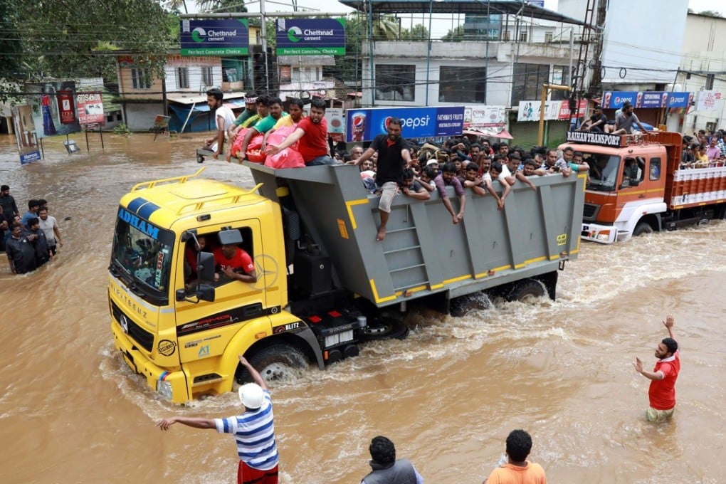 Trucks carry rescued locals to safety in the Ernakulam district of Kochi, in flood-ravaged Kerala. Photo: AFP