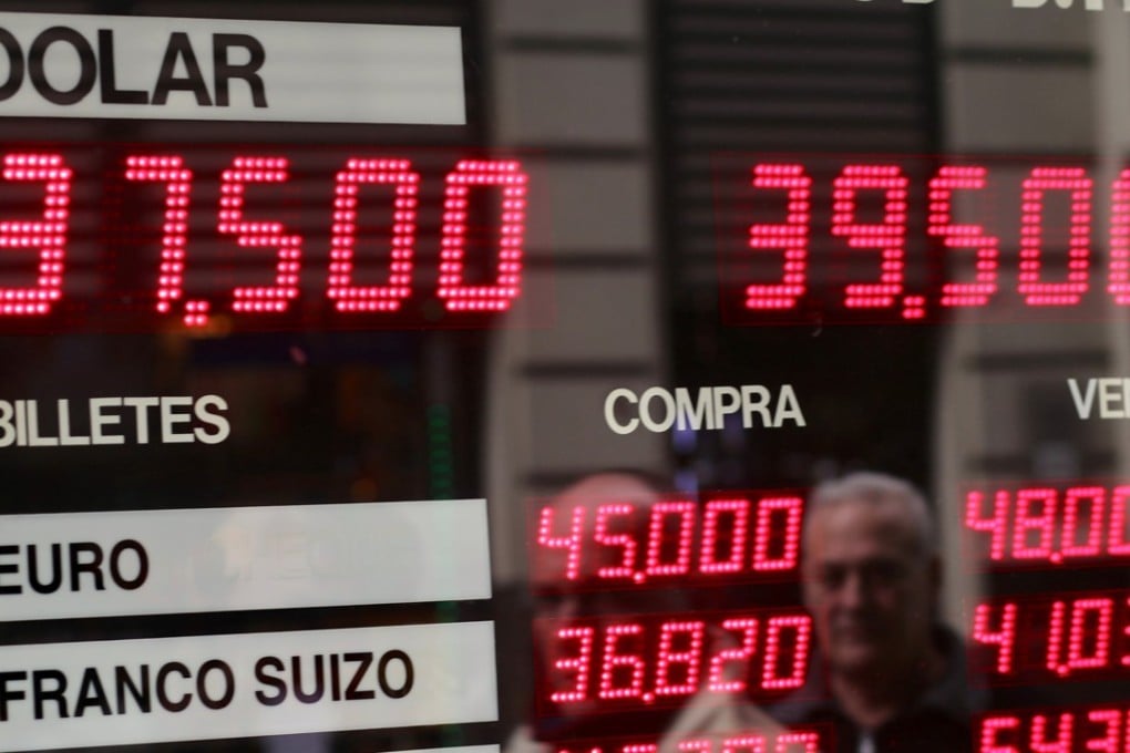 People look at a currency exchange board in Buenos Aires' financial district in Argentina on August 31. Difficulties for emerging markets have been exacerbated by Argentina, where the currency is plunging and the threat of another recession looms, despite a US$50 billion support package from the International Monetary Fund. Photo: Reuters