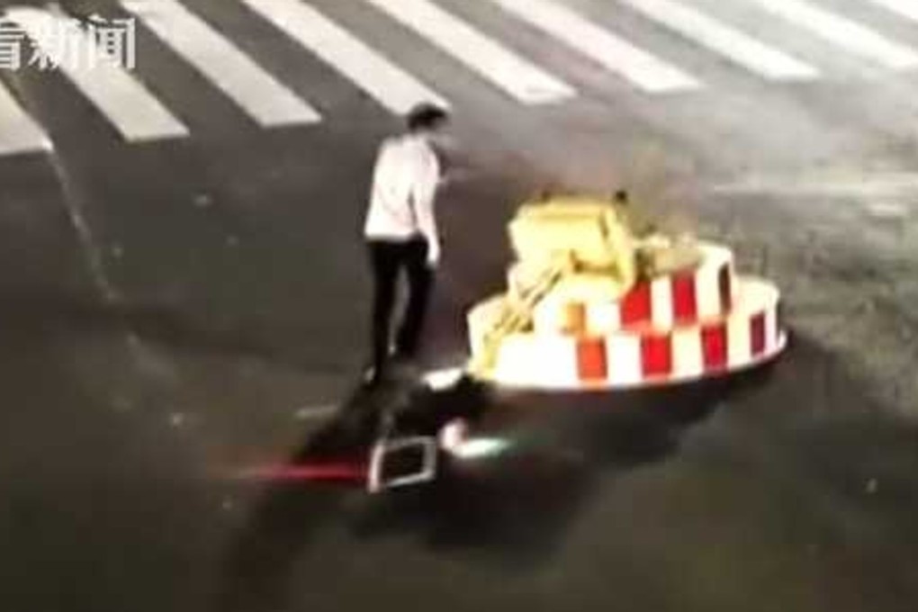 A motorist in central China was detained for demolishing a temporary traffic light in an apparent fit of pique. Photo: Handout