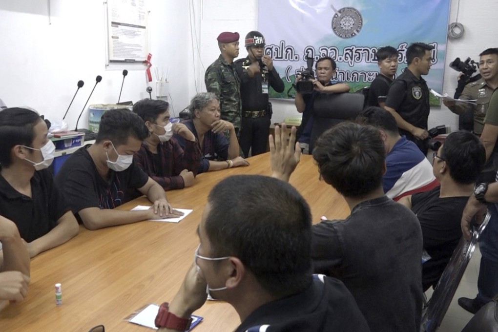 Thai policemen at Koh Tao police station investigate 12 people who shared a Facebook post on a rape report. Photo: AP