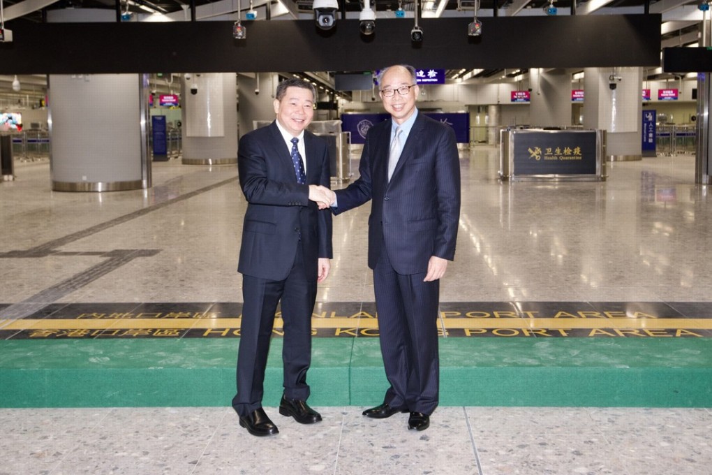 Hong Kong’s transport chief Frank Chan Fan (left) shakes hands with Lin Ji, the deputy secretary general of Guangdong province, at the commissioning of the mainland port area at the West Kowloon terminus of the cross-border express rail link, on September 3. Photo: Handout