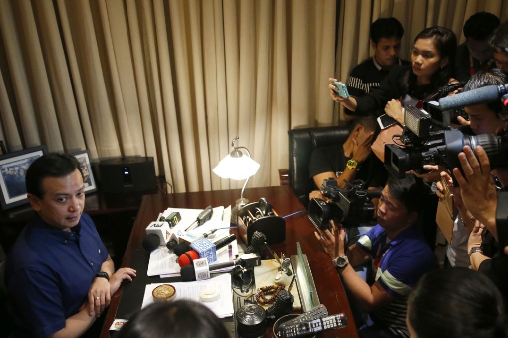 Senator Antonio Trillanes being interviewed inside his office in the Philippine Senate, where he has remained holed up for the past four days. Photo: AP