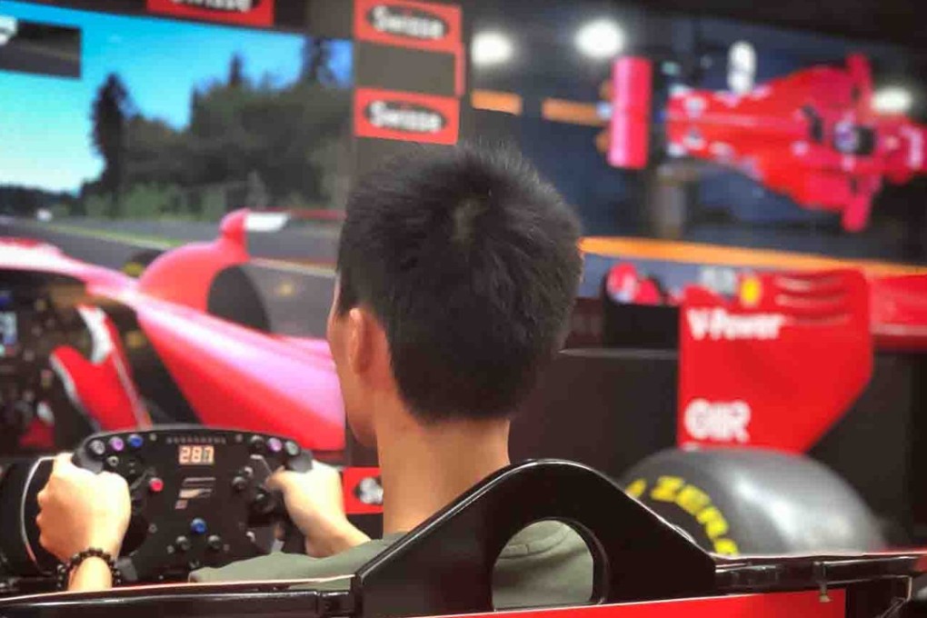 A budding driver tries out a simulator. Photo: Sideways
