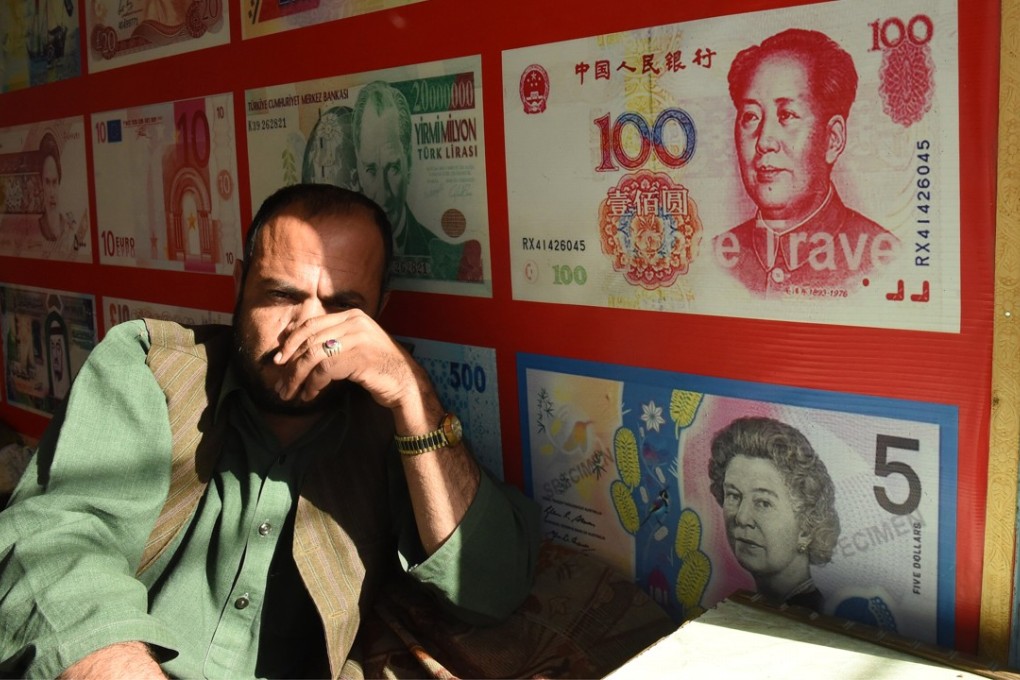 A currency dealer in Quetta, Pakistan. As of the end of the second quarter, overseas institutional and individual holdings of yuan-denominated financial assets totalled US$717 billion, according to ICBC International. Photo: AFP