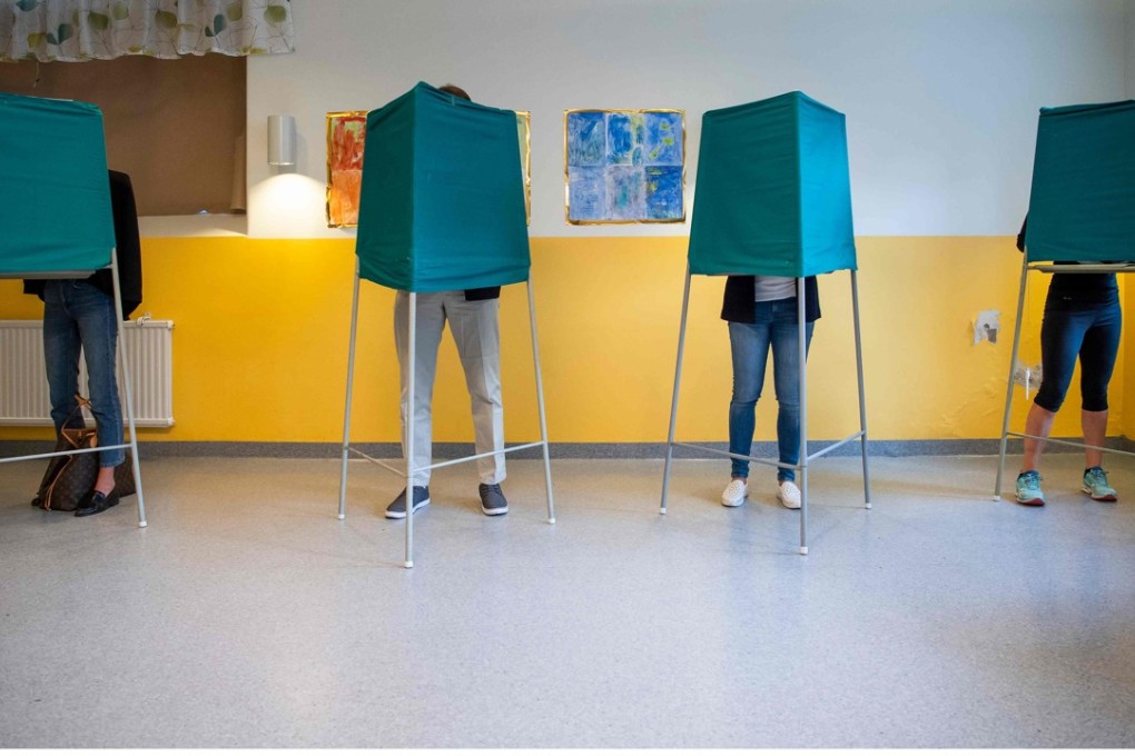 People stand in booths at a polling station during the Swedish general elections in Stockholm on September 9, 2018. Photo: AFP