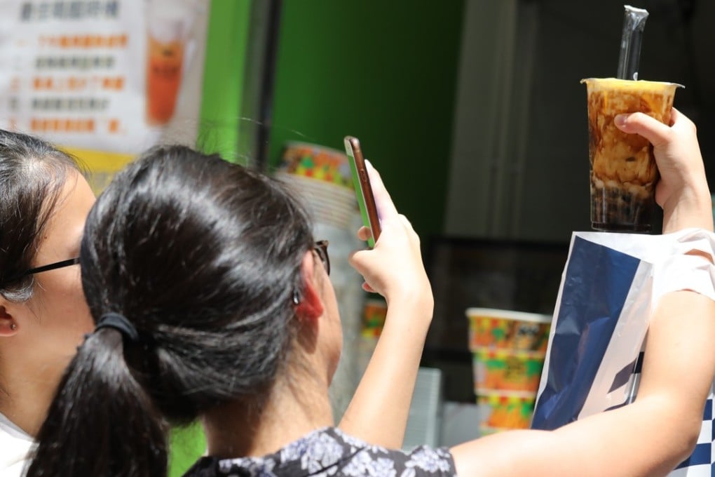 Bubble tea fans take selfies at Tiger Sugar in Causeway Bay. Photo: SCMP/ Dickson Lee