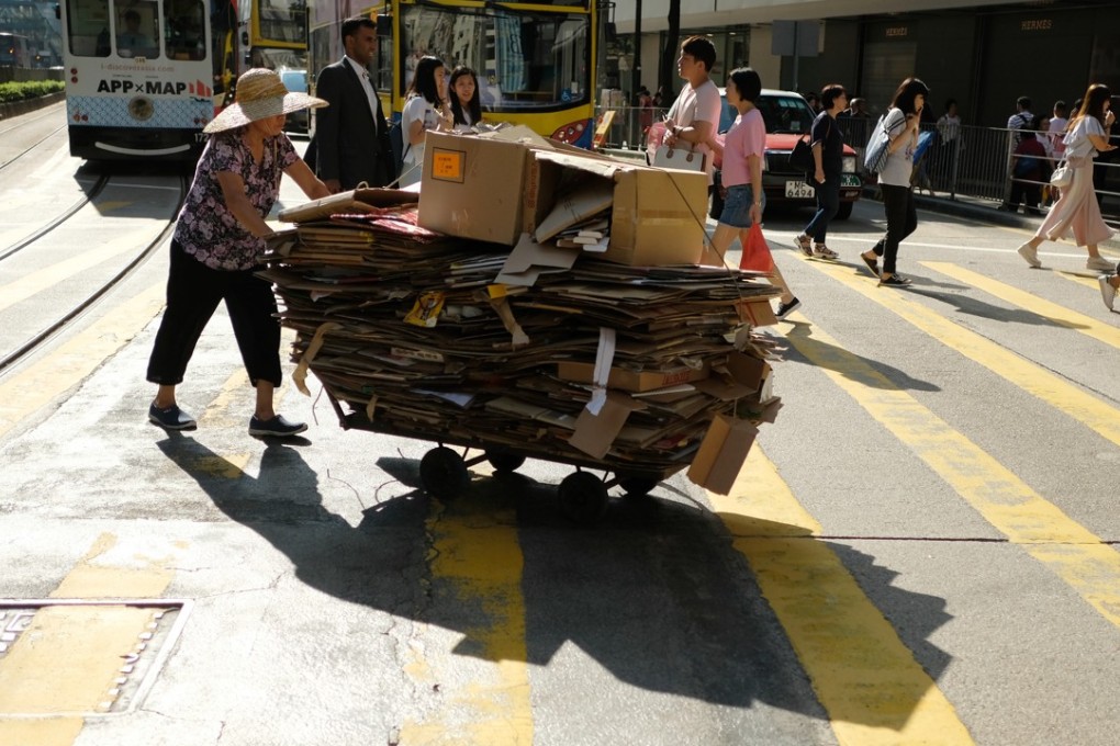 A woman pushes a trolley full of cardboard in Causeway Bay. Photo: Fung Chang