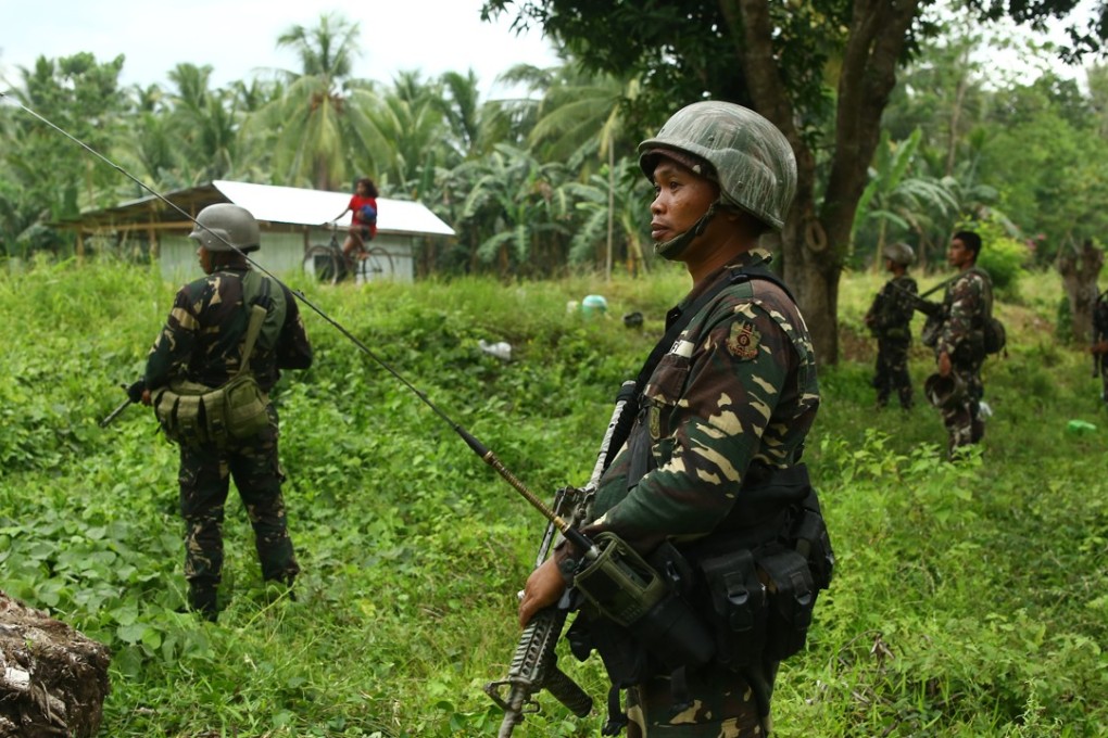 Soldiers patrol a village in southern Philippines. Photo: AFP
