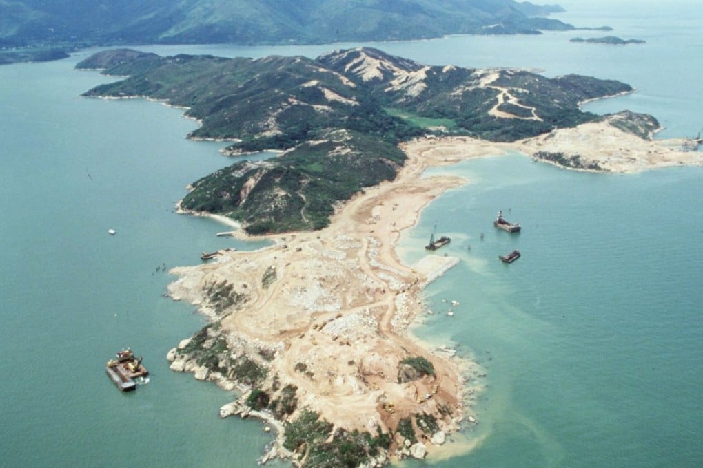 An aerial view of Chek Lap Kok island, with Lantau Island in the background, in mid-1991, as blasting operations begin for the new Hong Kong International Airport. Photo: SCMP