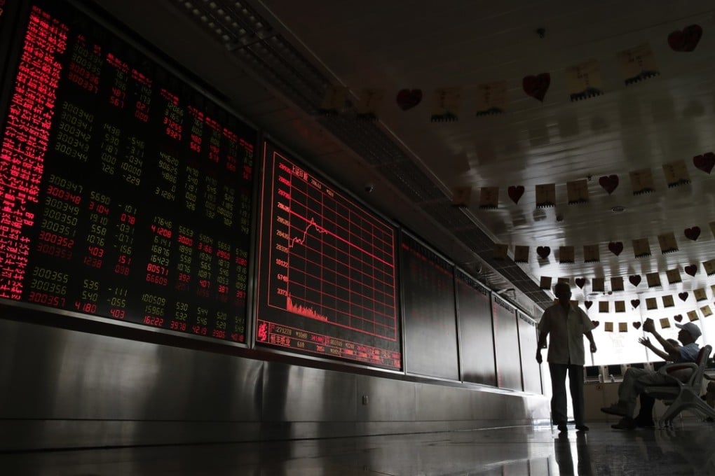 People react as they monitor stock prices at a brokerage house in Beijing, on August 16, after Asian shares fell due to investor concern over slowing economic growth, especially in China. Photo: AP