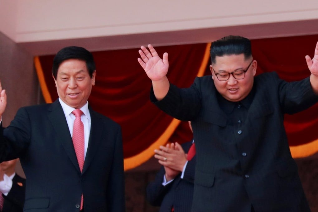 North Korean leader Kim Jong-un and China's Li Zhanshu, chairman of the Standing Committee of the National People's Congress (NPC), wave while attending the military parade in Pyongyang. Photo: Reuters