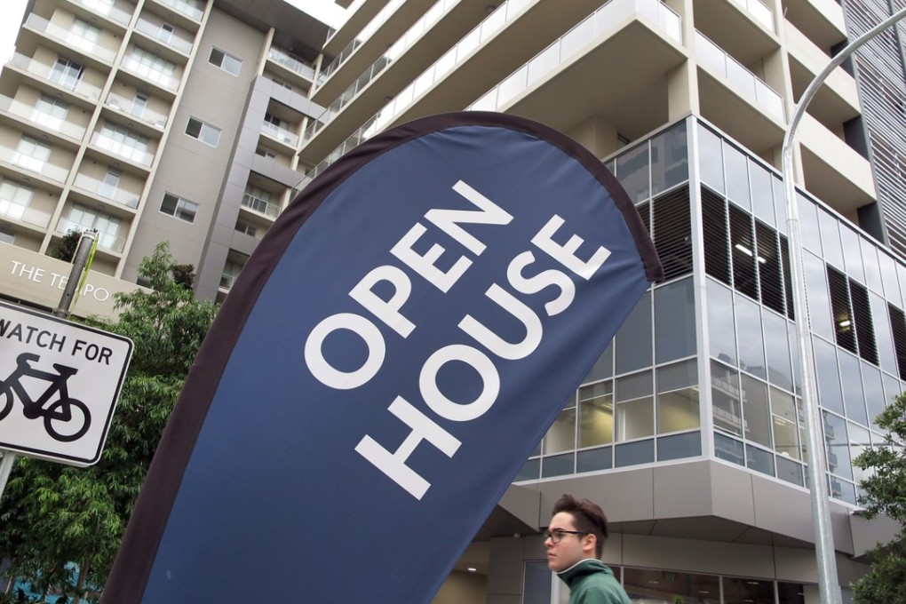 Signs advertising flats for sale in Sydney. Photo: AFP