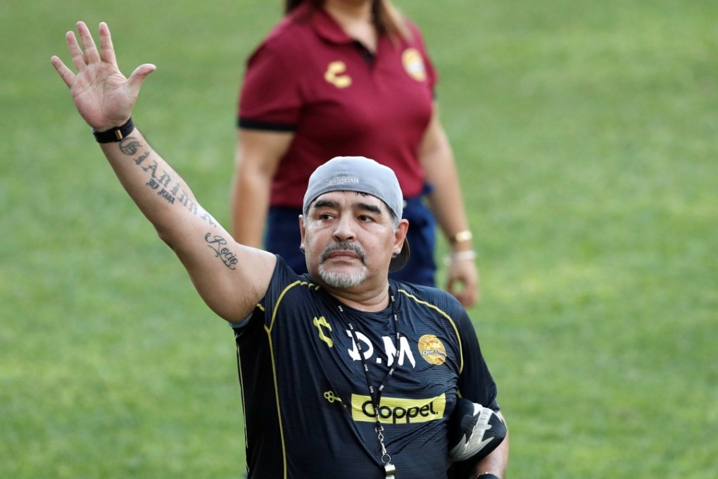 Argentinian soccer legend Diego Armando Maradona waves to fans during his first training session as coach of Dorados. Photo: Reuters