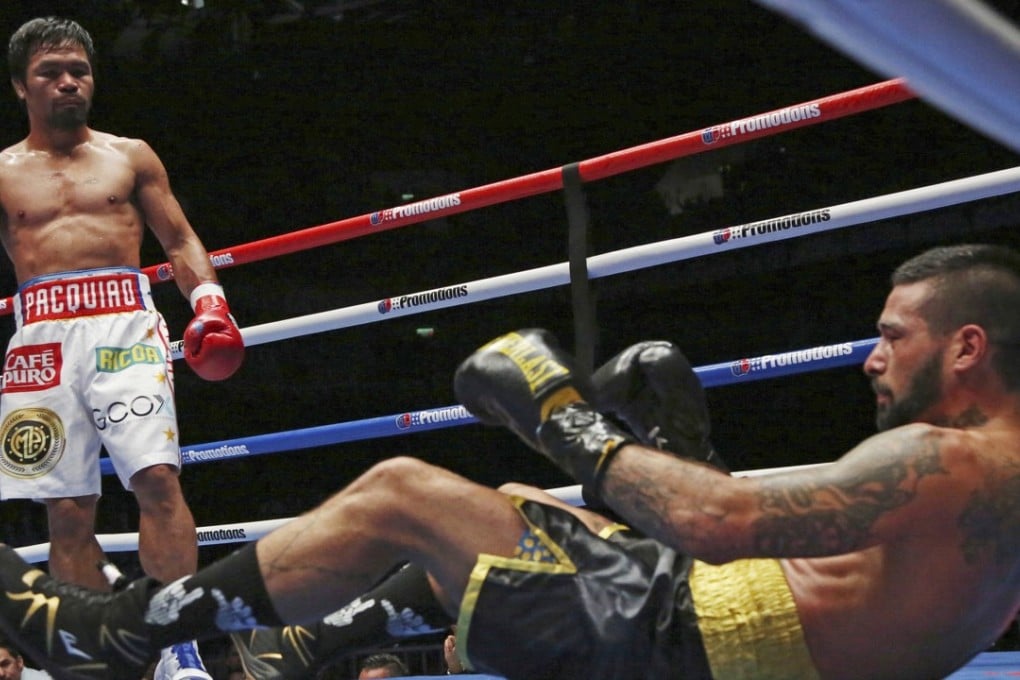 Lucas Matthysse falls after being hit by Manny Pacquiao during their WBA world welterweight title bout in Kuala Lumpur. Photo: AP