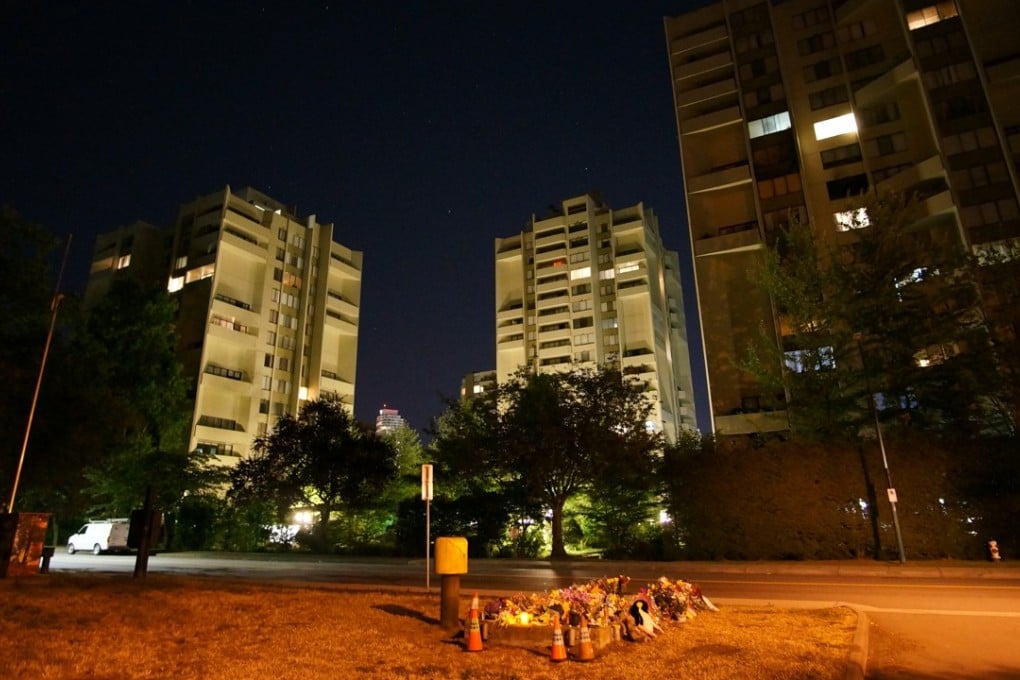 Tower blocks loom over a makeshift memorial to murder victim Marrisa Shen, on the southeastern edge of Central Park in Burnaby, British Columbia, on July 24. Photo: Ian Young