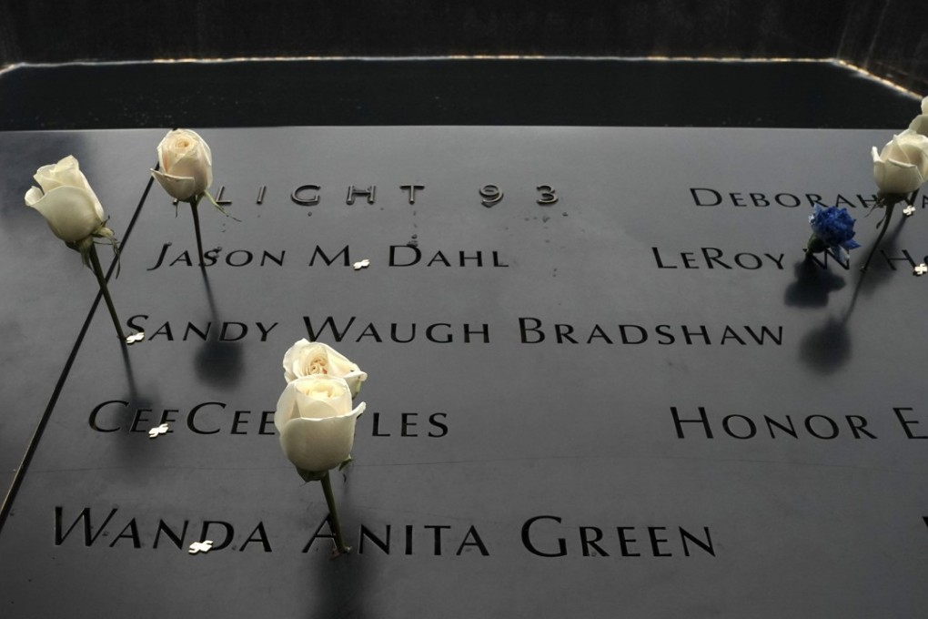 Flowers placed on names of people killed on September 11 on the wall around the south pool at the ground zero memorial site in New York. Photo: AFP