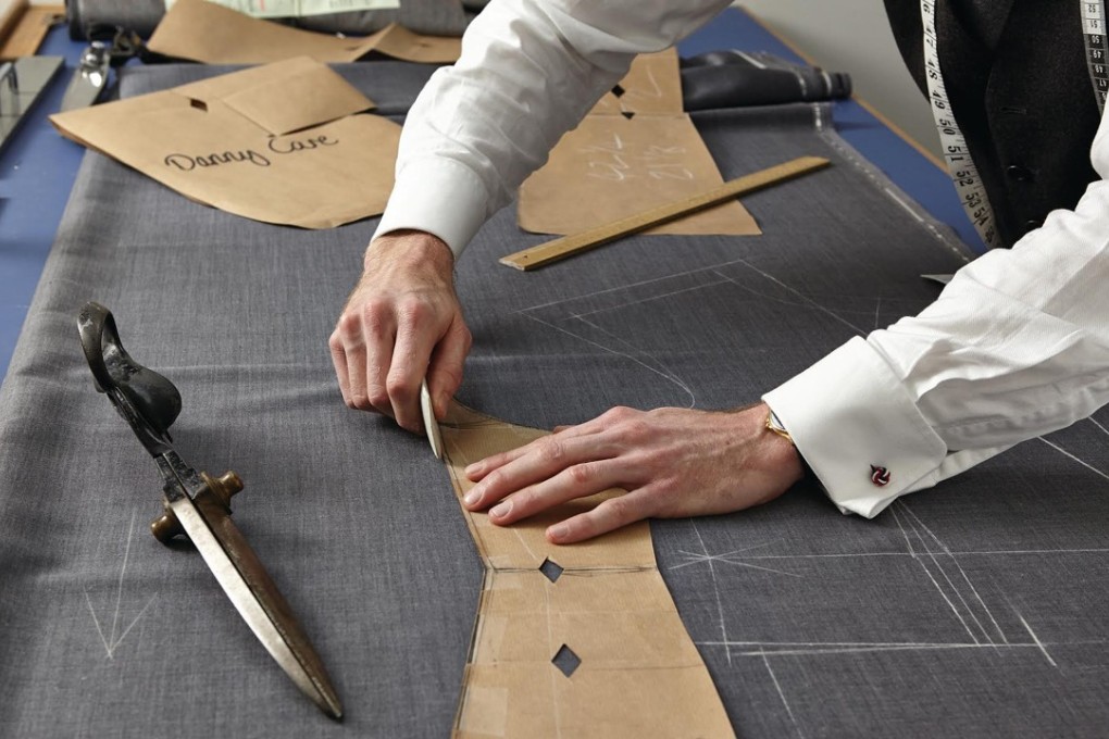 A cutter at work at Stowers London, a firm of Savile Row tailors.