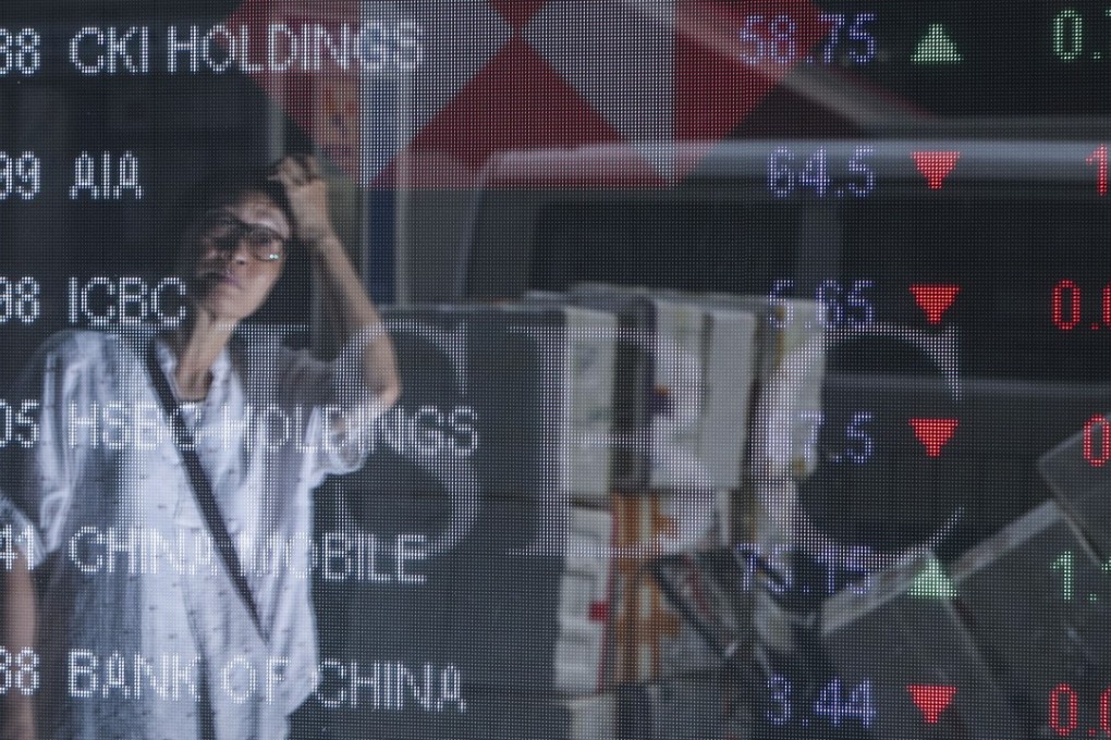 A man is reflected in an electronic board displaying the Hang Seng Index in Mong Kok on September 6. The Hong Kong stock market slipped into bear territory on Monday. Photo: Winson Wong