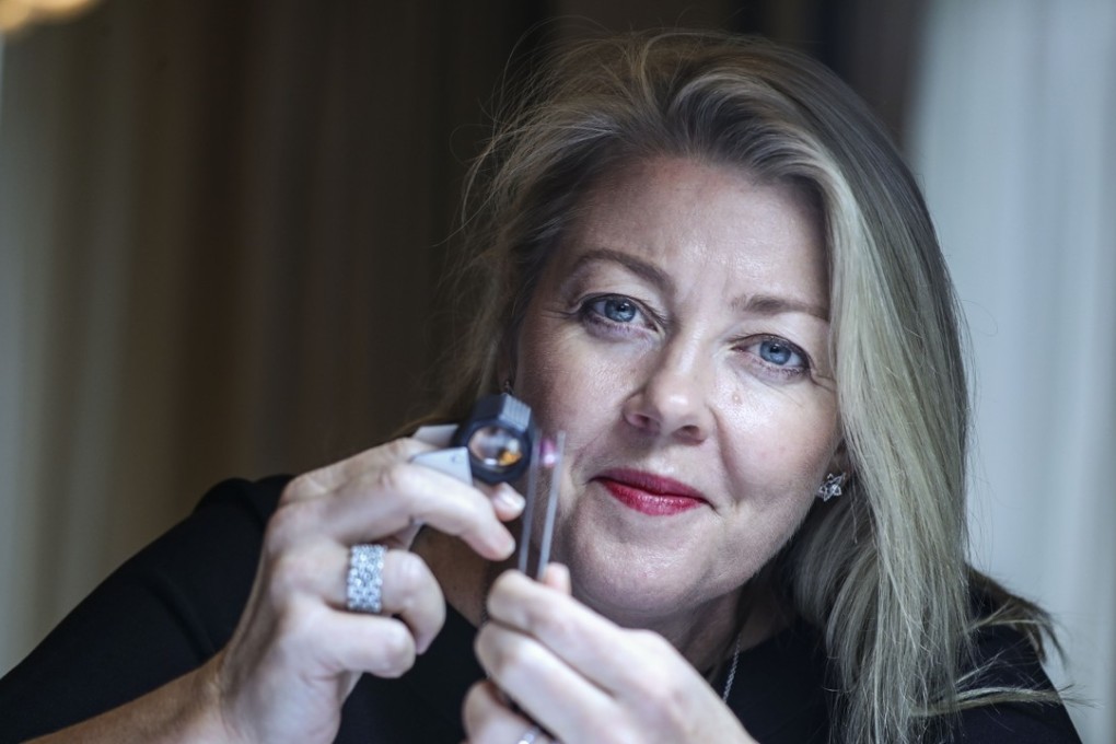 Josephine Johnson, director of global marketing at Rio Tinto Diamonds, with one of the 63 pieces of rare pink and red diamonds that are currently on display in Hong Kong. Photo: Edward Wong
