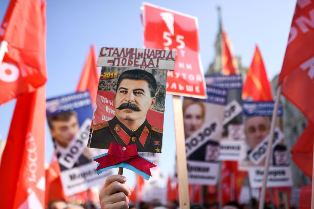 Russian Communist Party supporters carry red flags and the portrait of former Soviet leader Josef Stalin as they take part in a rally in Moscow on September 2. Photo: Agence France-Presse