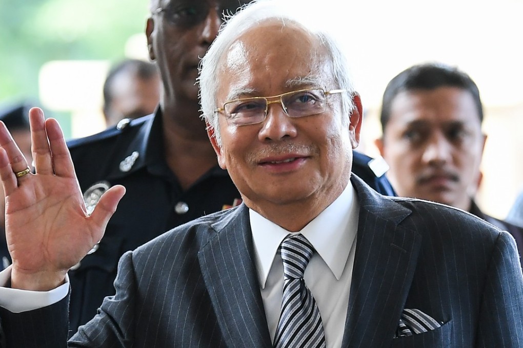 Malaysia’s former prime minister Najib Razak waves as he arrives at court in Kuala Lumpur on August 10, 2018. Photo: AFP