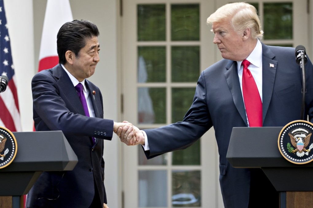 U.S. President Donald Trump, right, shakes hands with Shinzo Abe, Japan's prime minister, positioned himself not just as US President Donald Trump’s man in Asia, but his closest ally among world leaders, writes William Pesek. Photo: Bloomberg
