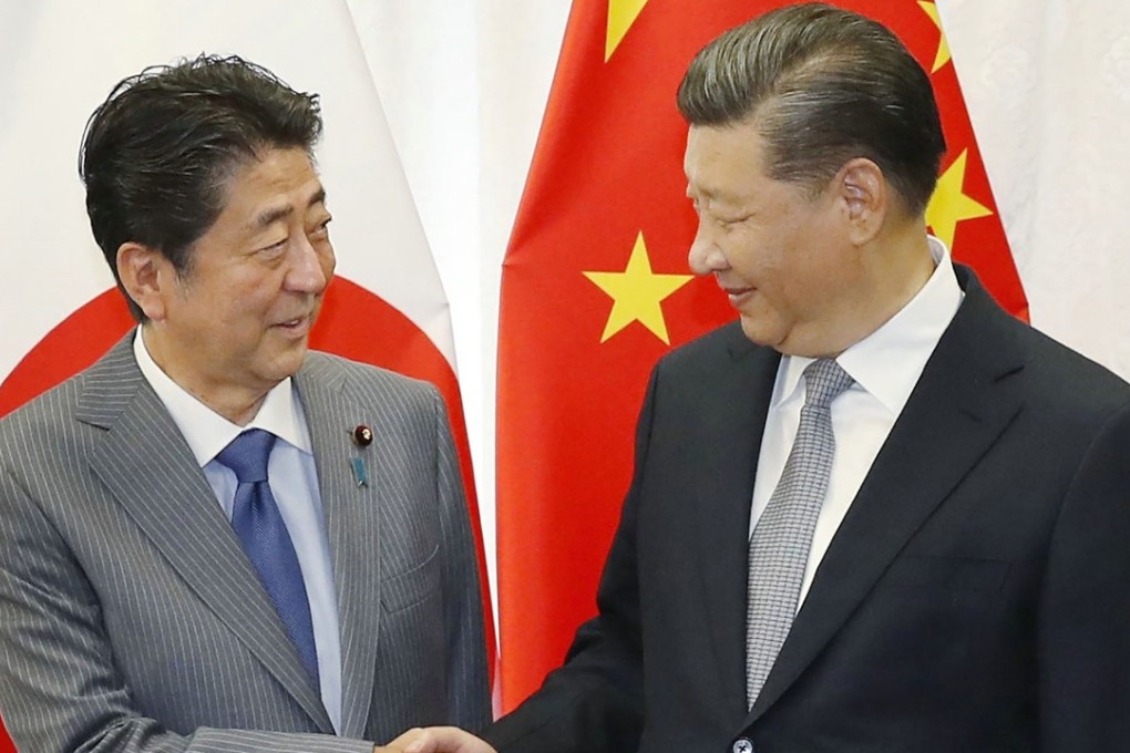 Japan's Prime Minister Shinzo Abe (left) will have his first bilateral visit to Beijing as soon as next month, to be reciprocated by President Xi Jinping at a later date. Photo: Jiji Press / AFP