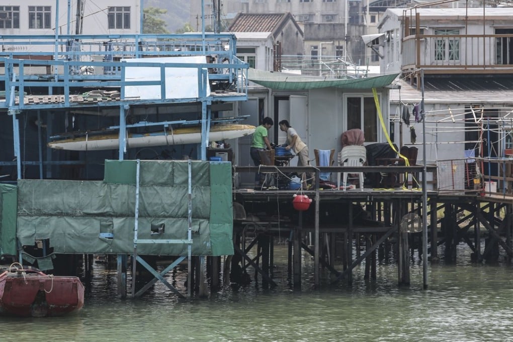 Volunteers help residents of Tai O stilt houses prepare for the typhoon on Saturday. Photo: Edward Wong