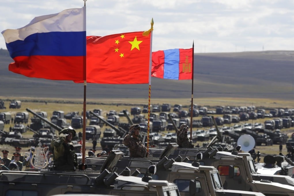 Russian, Chinese and Mongolian national flags fly from armoured vehicles during joint military exercises on Thursday in eastern Siberia. Photo: AP