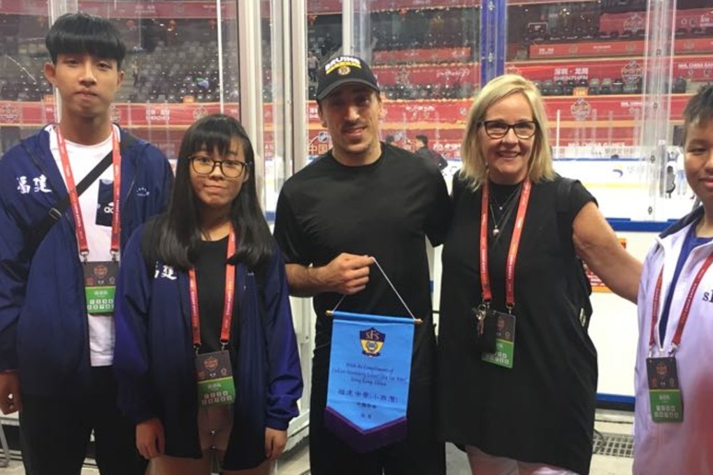 Hong Kong secondary school students and their teacher Mary Beth Osburn with Boston Bruins player Brad Marchand at the NHL China Games in Shenzhen. Photo: Jonathan White