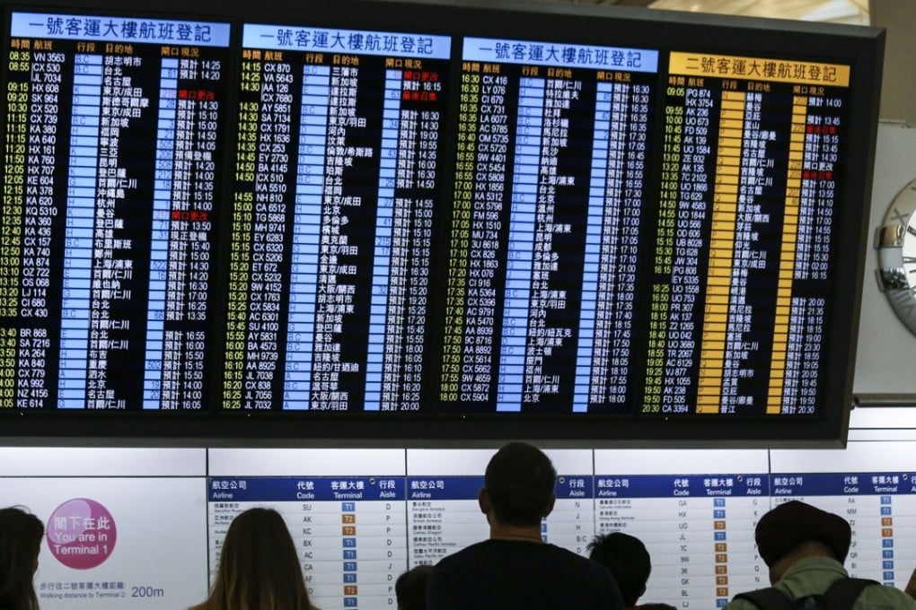 A flight information board at Hong Kong International Airport on Lantau Island. Photo: Dickson Lee