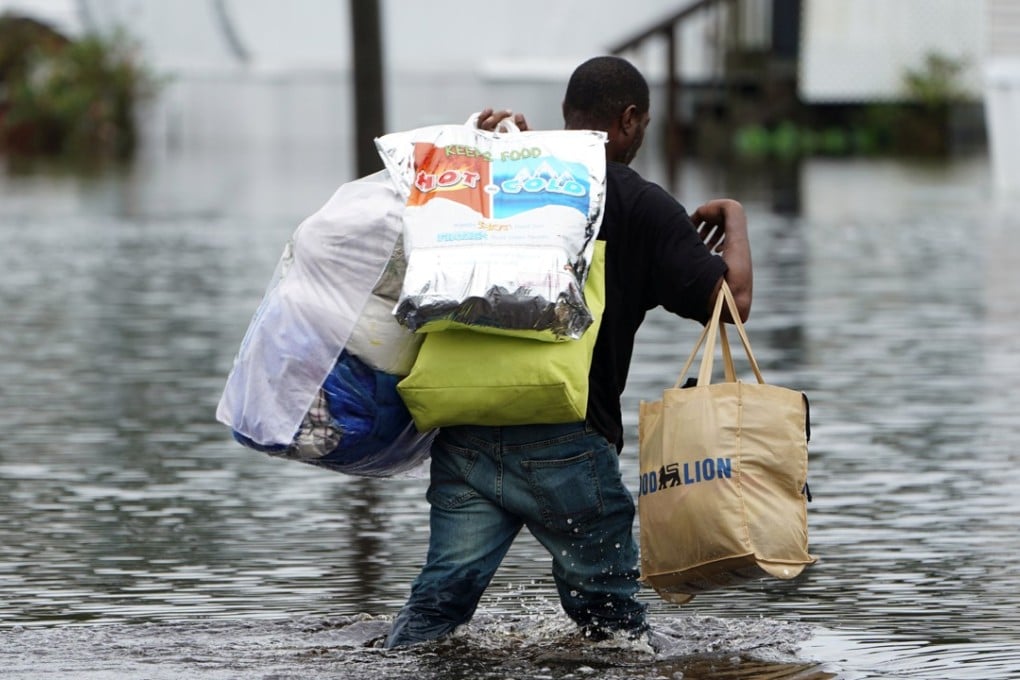 A man walks through a flooded street in Piny Green, North Carolina, on Sunday. Photo: Reuters