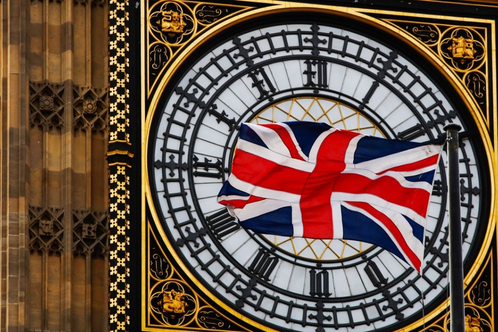 A British Union flag flies beside a clock face on Elizabeth Tower, also known as “Big Ben”, in London, in this 2017 file photo. Photo: Bloomberg