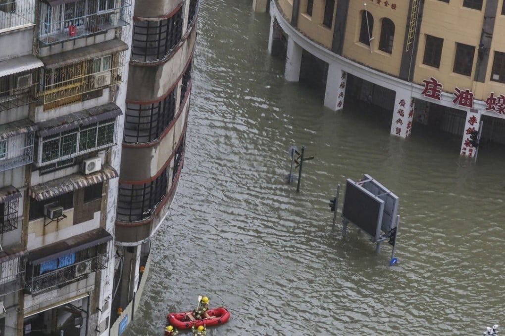Firefighters using a rubber boat to help residents on Avenida de Almeida Ribeiro in Macau during the onslaught of Super Typhoon Mangkhut on Sunday, September 2018. Photo: SCMP / Dickson Lee