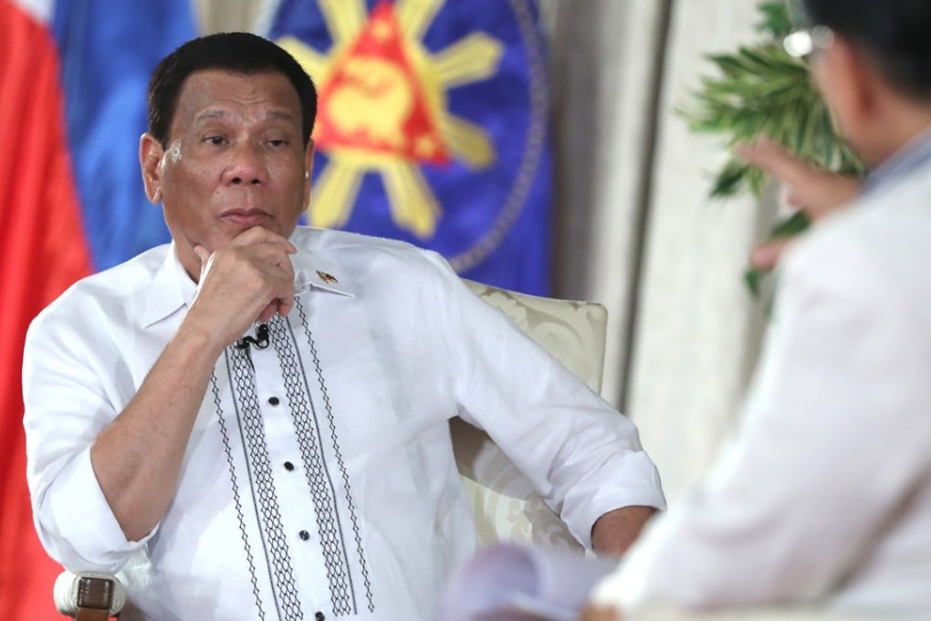 Philippine President Rodrigo Duterte listening to a question from chief presidential legal counsel Salvador Panelo during a state television talk show at Malacanang palace in Manila on Tuesday September 11, 2018. Photo: AP