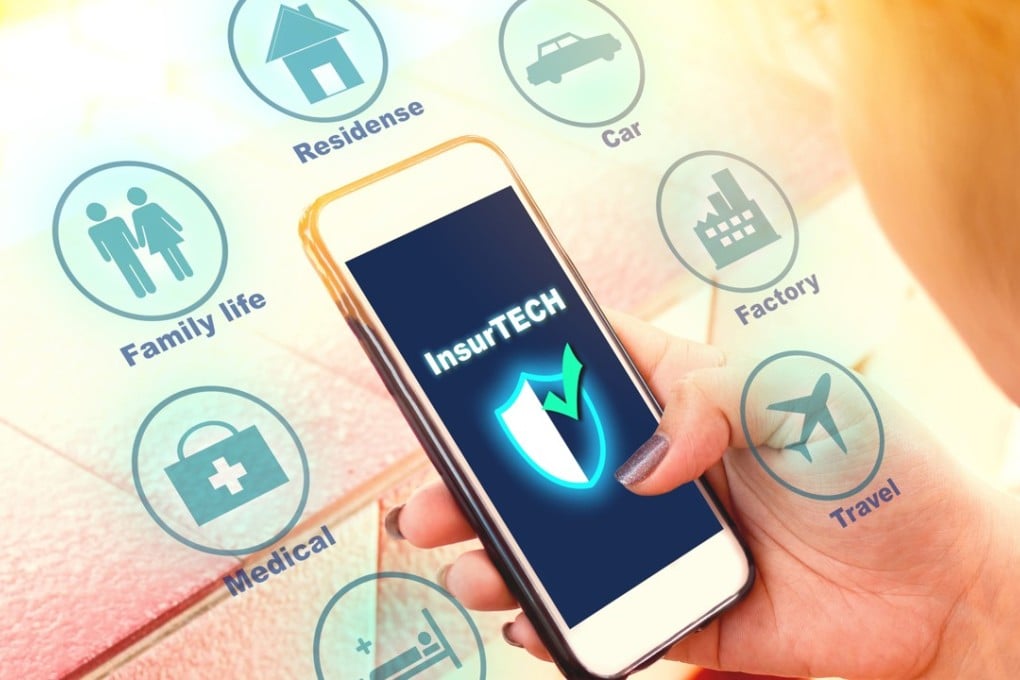 An insurance technology concept, with woman looking at data information on a smartphone. Photo: Shutterstock