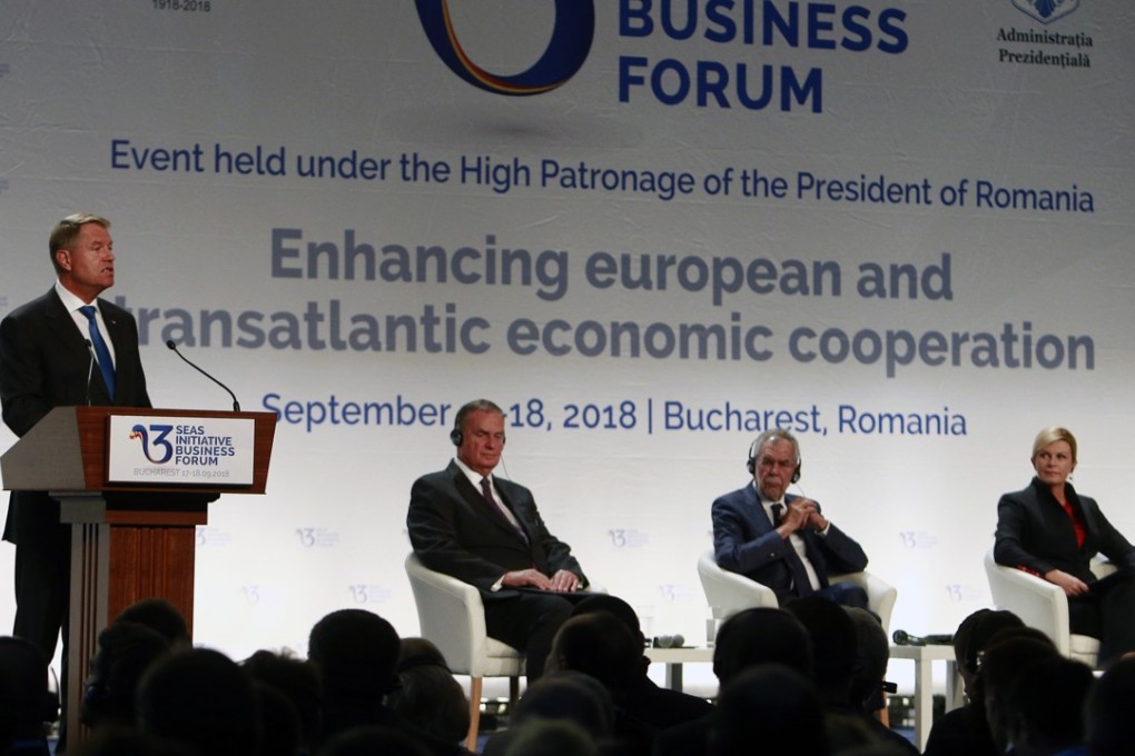 Romania’s President Klaus Iohannis, at left, speaks at the opening of the Three Seas Initiative Business Forum in Bucharest, Romania. Photo: EPA-EFE