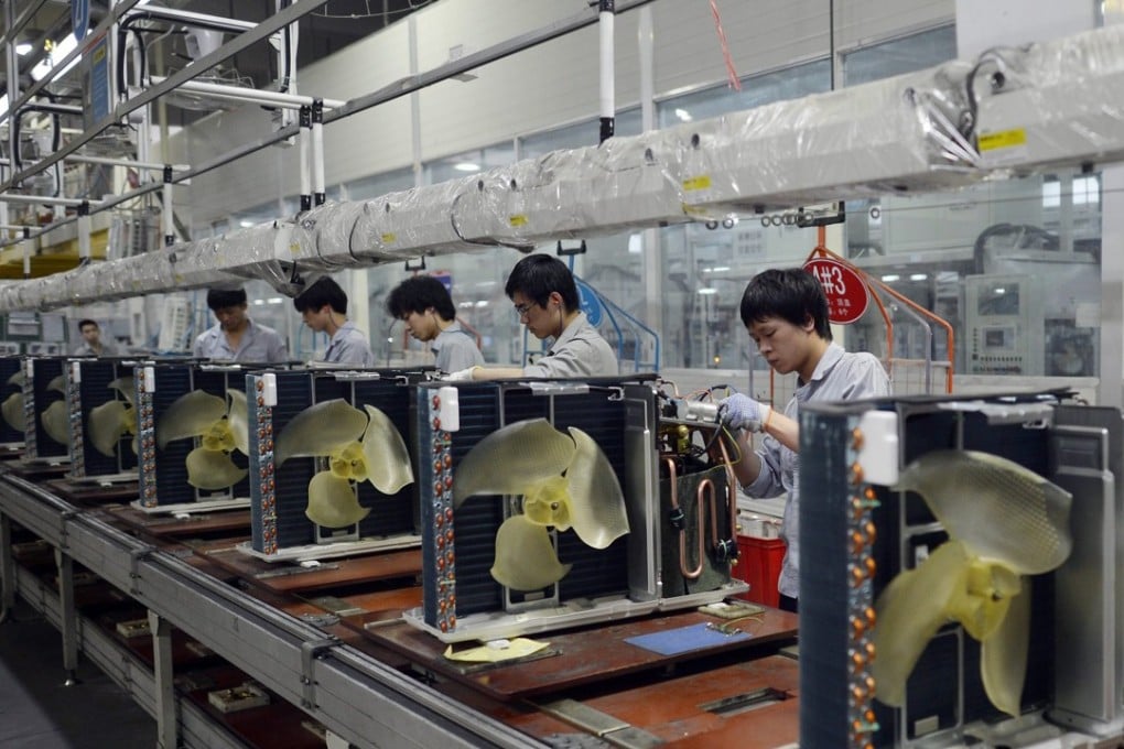 Workers assemble air conditioners at a Gree Electric Appliances factory in Wuhan, China. China is already the world’s top producer of air conditioners and is expected to be a key player in the installation of 1 billion more globally over the next decade. Photo: EPA