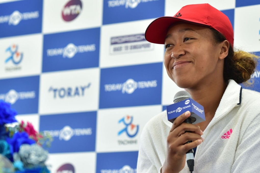 US Open champion Naomi Osaka is all smiles during a press conference at the Pan Pacific Open tournament in Tokyo. Photo: AFP