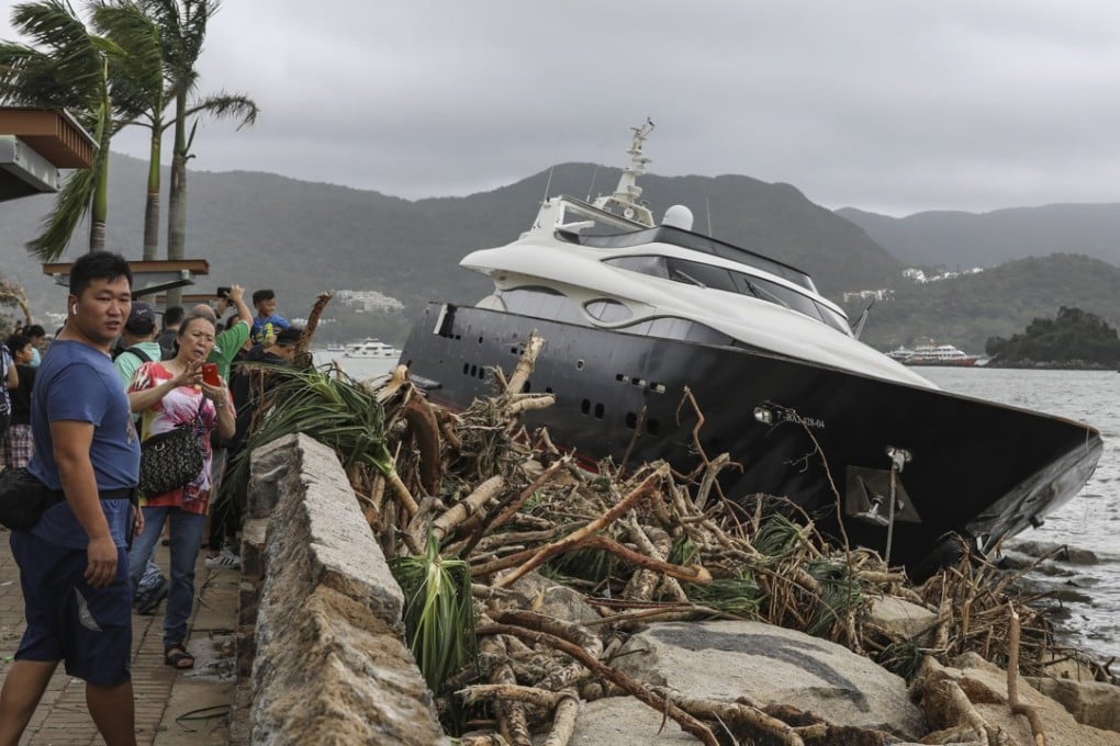 A boat was thrown on to the rocks near Sai Kung Pier by Typhoon Mangkhut. Photo: May Tse