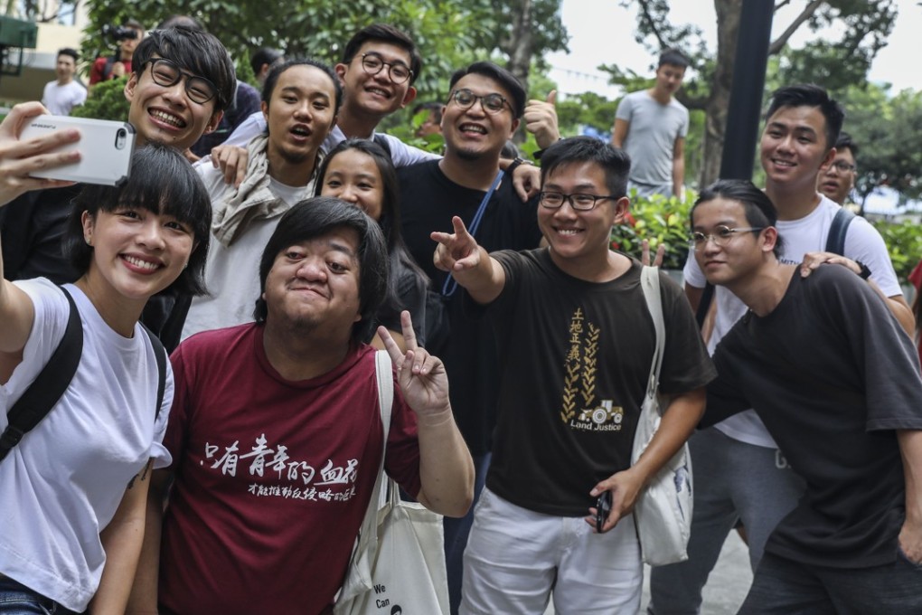 Raphael Wong (second from right, front row) celebrates with others after the Court of Final Appeal overturned his and 12 other activists’ jail sentences for a 2014 protest. Photo: Sam Tsang